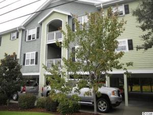 a house with a truck parked in front of it at Charming Condo 2min Walk From The Famous Boardwalk in Myrtle Beach