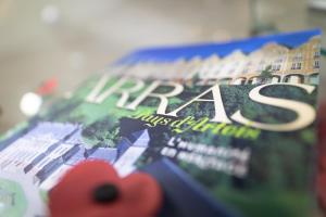 a book with a red flower on the cover at Holiday Inn Express Arras, an IHG Hotel in Arras