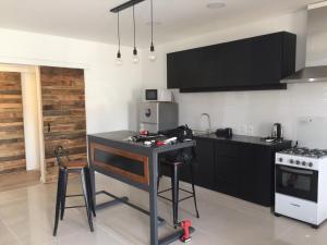 a kitchen with a black counter and a stove at RELAX II in Paysandú