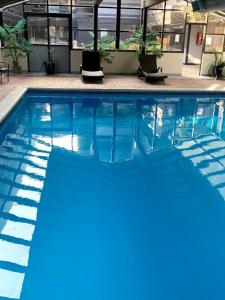 a swimming pool with blue water in a building at GetAways at Park Regency Resort in Park City