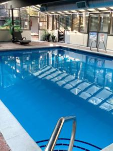 a swimming pool with blue water in a building at GetAways at Park Regency Resort in Park City