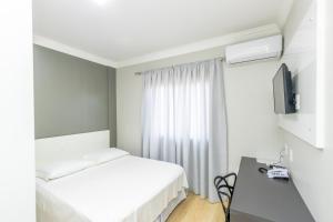 En eller flere senge i et værelse på Caxias Thermas Hotel