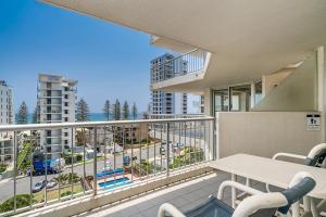 
a hotel room with a balcony overlooking a city at Rainbow Bay Resort Holiday Apartments in Gold Coast
