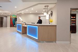 a man standing at a counter in a hospital lobby at Holiday Inn Express Hollywood Walk of Fame by IHG in Los Angeles