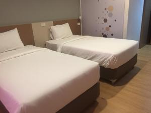 Postel nebo postele na pokoji v ubytování Ingnaam Hotel