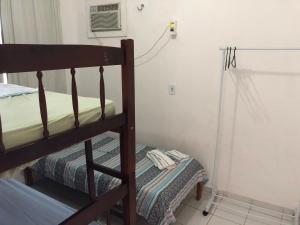 a bedroom with a bunk bed and a small room with a window at Betesda in São Luís