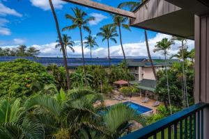 an aerial view of a resort with a pool and palm trees at Top Floor Ocean Views Condo in Kihei