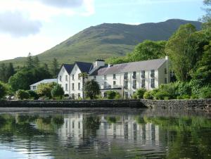 a house on a hill overlooking a lake at Leenane Hotel in Leenaun