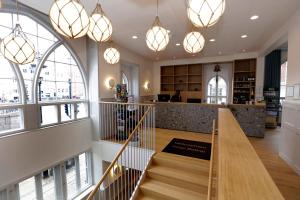a lobby of a store with a staircase and chandeliers at Hotel Bethel in Copenhagen