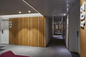 a hallway with wood panels and a hallway with a corridorngth at Silken Ramblas in Barcelona