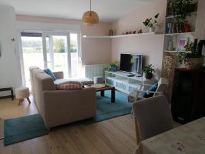 a living room with a couch and a tv at Apartman Kopriva in Koprivnica