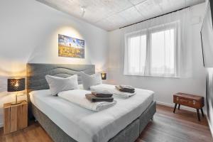 Postel nebo postele na pokoji v ubytování The Cloud Suite Apartments + 37 fotografií