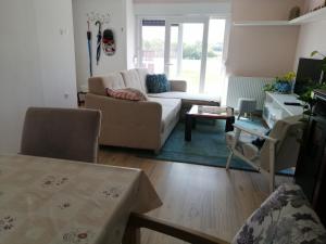 a living room with a couch and a table at Apartman Kopriva in Koprivnica
