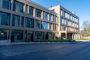 a large office building with a lot of windows at Nash Pratik Hotel in Geneva