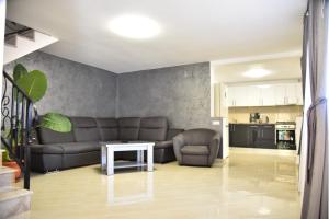 a living room with a couch and a table at Sophia Maria Caciulata in Caciulata
