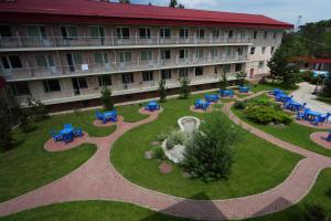 a building with a courtyard with tables and chairs at Olympica Hotel in Almaty