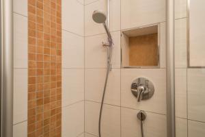 a shower with a shower head in a bathroom at Casa Rindler in Sigmarszell