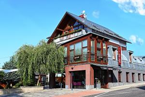 a building with a balcony on the side of it at Apart Hotel Jablonec in Jablonec nad Nisou +174 photos