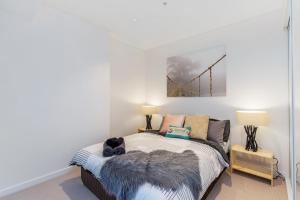 a bedroom with a bed with a dog on it at KOZYGURU SKYTOWER BRISBANE CBD 2 BED APT QBN222-1815 in Brisbane +4 photos