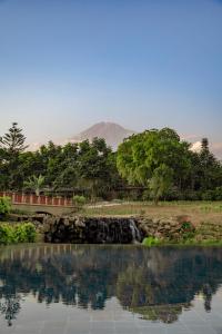 a body of water with a mountain in the background at Gran Melia Arusha in Arusha