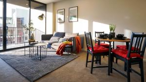 a living room with a couch and a table at KOZYGURU BRISBANE CBD 1 BED APT AMAZING VIEW QBN550-1601 in Brisbane