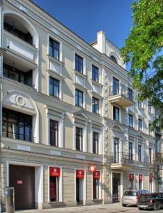 a large white building on a street with cars parked in front at Kopernika 8'3 - Market Square & Old Town in Krakow