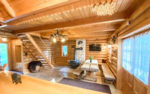 a log cabin living room with a large window at Sucholand in Miedziana Góra