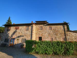 an old stone building with a sign on it at Belvilla by OYO Limone in Radda in Chianti