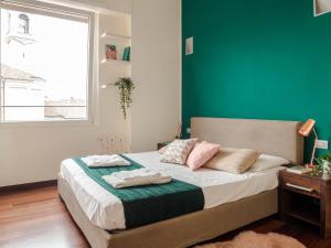A bed or beds in a room at The Best Rent - Bright two rooms apartment near Cattolica University