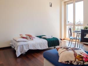 A bed or beds in a room at The Best Rent - Bright two rooms apartment near Cattolica University