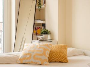 A bed or beds in a room at The Best Rent - Bright two rooms apartment near Cattolica University