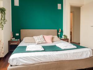 A bed or beds in a room at The Best Rent - Bright two rooms apartment near Cattolica University