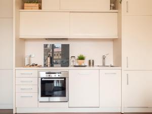 A kitchen or kitchenette at The Best Rent - Bright two rooms apartment near Cattolica University
