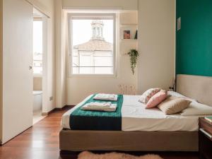 A bed or beds in a room at The Best Rent - Bright two rooms apartment near Cattolica University