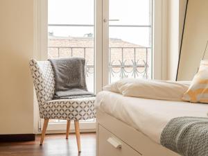 A bed or beds in a room at The Best Rent - Bright two rooms apartment near Cattolica University