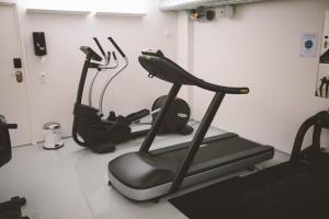 a gym with two exercise bikes and a treadmill at Andersen Boutique Hotel in Copenhagen