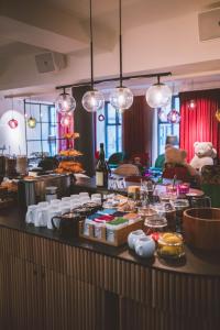 a buffet with food on a counter with lights at Andersen Boutique Hotel in Copenhagen