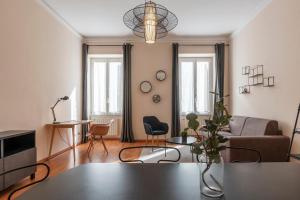 a living room with a couch and a table at Rione Prati Apartment - MM Lepanto in Rome