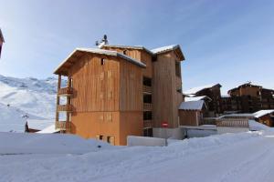 a building with snow in front of it at Beausoleil Appartements VTI in Val Thorens