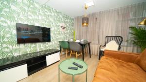 a living room with a couch and a table at Leidse Square City Centre Private Apartments in Amsterdam