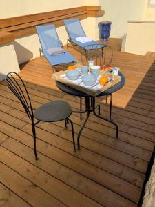 Bernis的住宿－Elle & Lui en Jacuzzi，橙色木制甲板上的桌椅