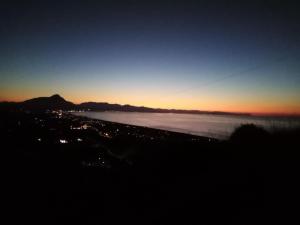 a view of the ocean at sunset at Villa Verde in Cefalù