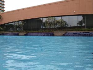 a building with a pool of water in front of it at Times Square Service Residents, Kuala Lumpur in Kuala Lumpur