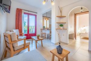 a living room with a chair and a table at Villa Vicky in Hersonissos