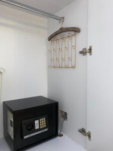 a microwave oven sitting on top of a wall at Royal Suite Korca in Korçë