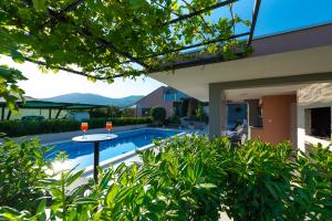 uma casa com piscina e uma mesa com duas bebidas em Villa Toni with 5 bedrooms and heated pool em Kaštela