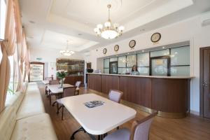 a restaurant with tables and chairs and a bar at Hotel Gogol House in Saint Petersburg