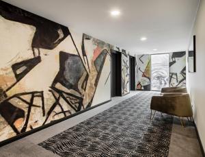 a room with a large painting on the wall at Novotel Geelong in Geelong