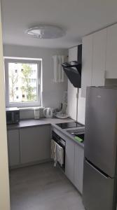 a kitchen with a stainless steel refrigerator and a window at Mieszkanie 2 pokojowe Pomorzany in Szczecin