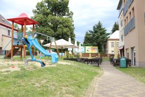 a playground in a park with a slide at Hotel Petra in Liberec